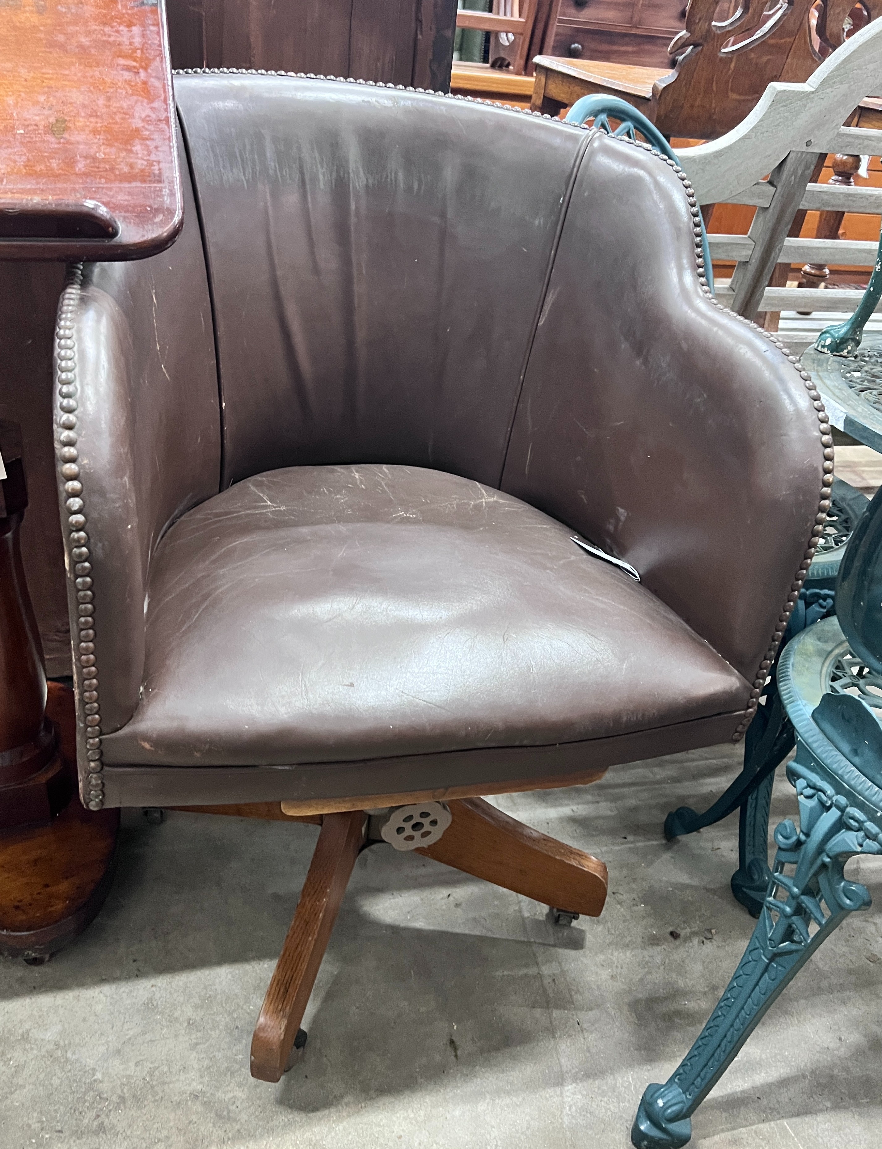 A mid century oak swivel desk chair, width 58cm, depth 47cm, height 86cm